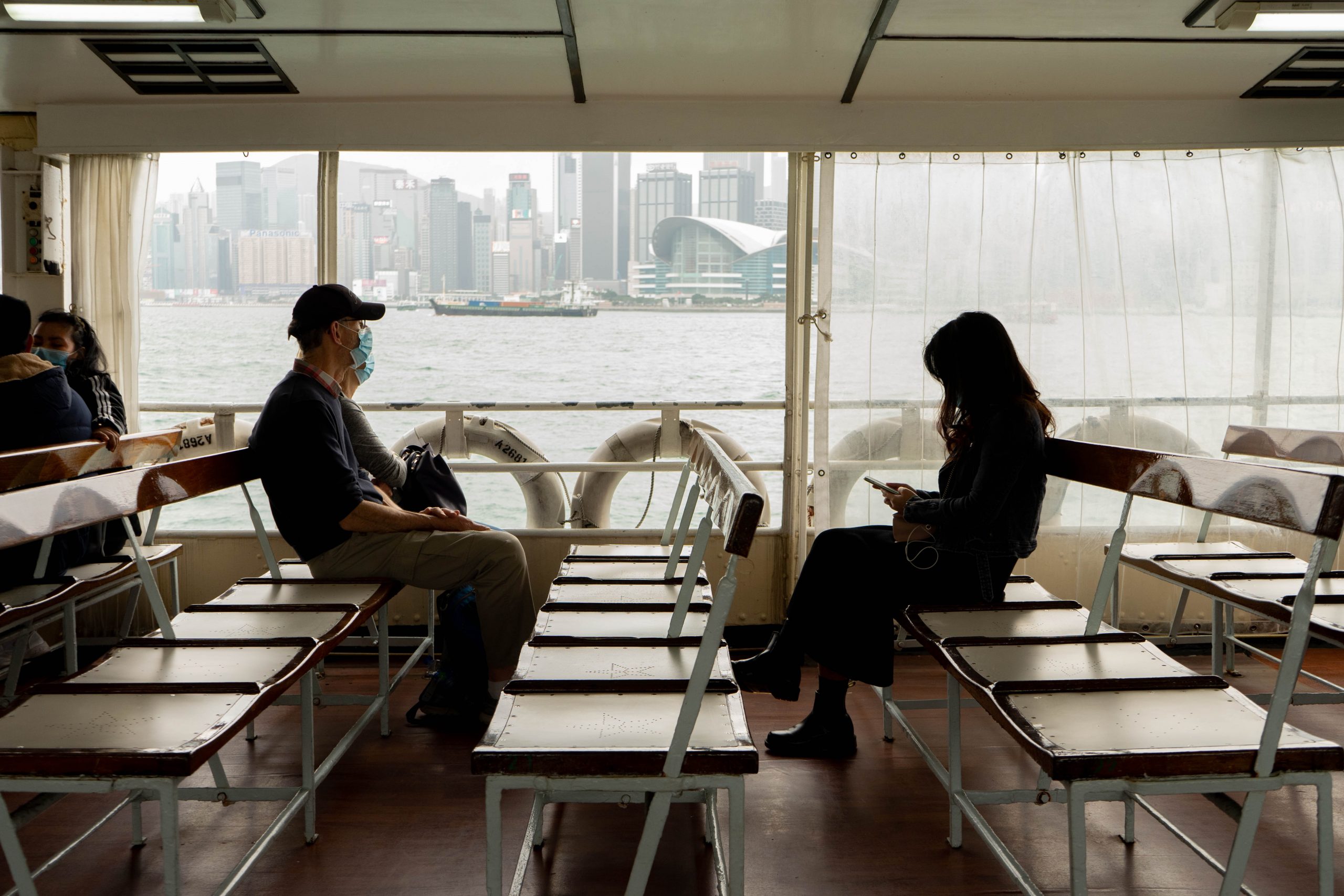 People wear masks and maintain physical distance while riding a ferry. Photo by Big Dodzy.